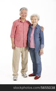 Full Length Studio Shot Of Chinese Senior Couple