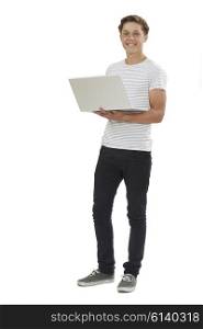 Full Length Studio Shot Of Teenage Boy Using Laptop