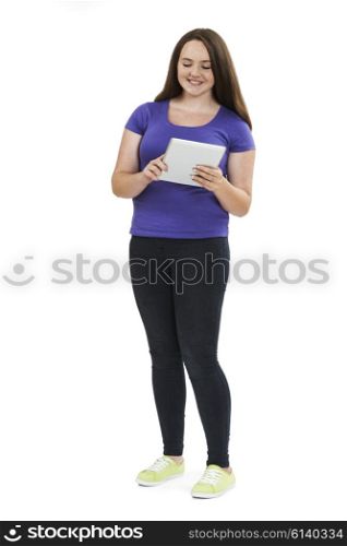 Full Length Studio Shot Of Teenage Girl Using Digital Tablet
