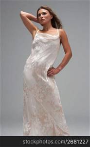 Full Length Studio Shot Of Young Woman In White Evening Dress