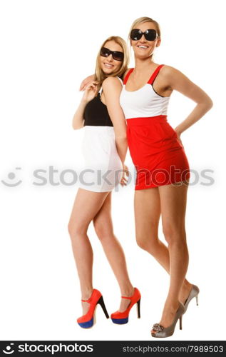 Full length two beautiful sexy crazy women fashion girls in summer clothes sunglasses. Studio portrait isolated on white