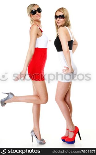 Full length two sexy women wearing mini skirts and sunglasses. Fashion photo, summer vacation.