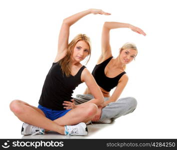 Full length two women doing stretching fitness exercise isolated on white background