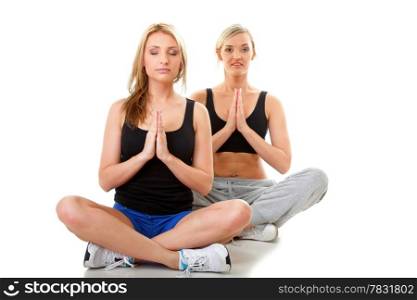 Full length two women doing stretching fitness exercise yoga, isolated on white background