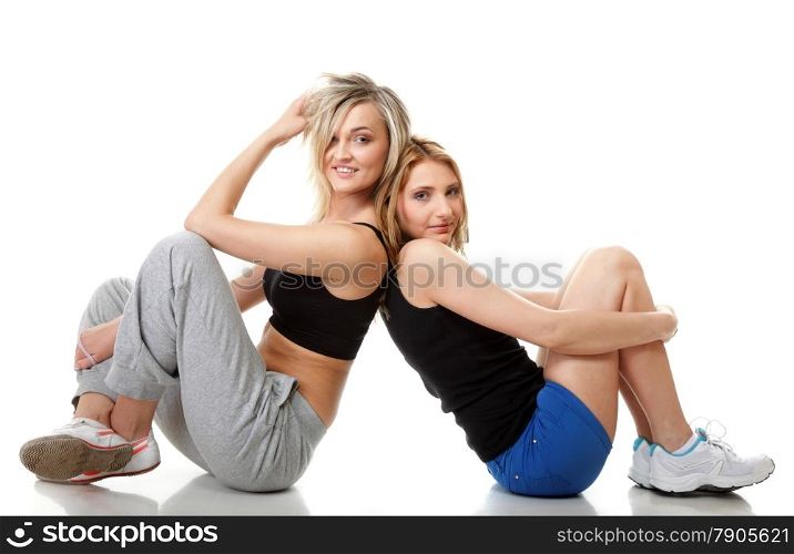 Full length two young sporty women after intense workout, isolated on white background.