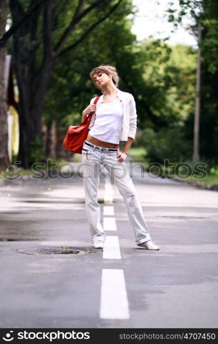 Full length, walking woman in blue jeans