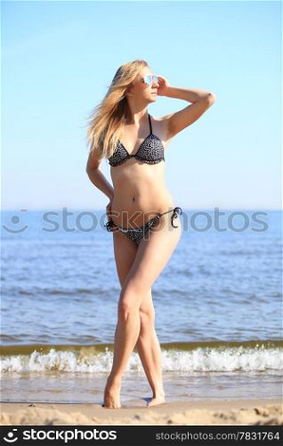 Full length woman in bikini at the sandy beach