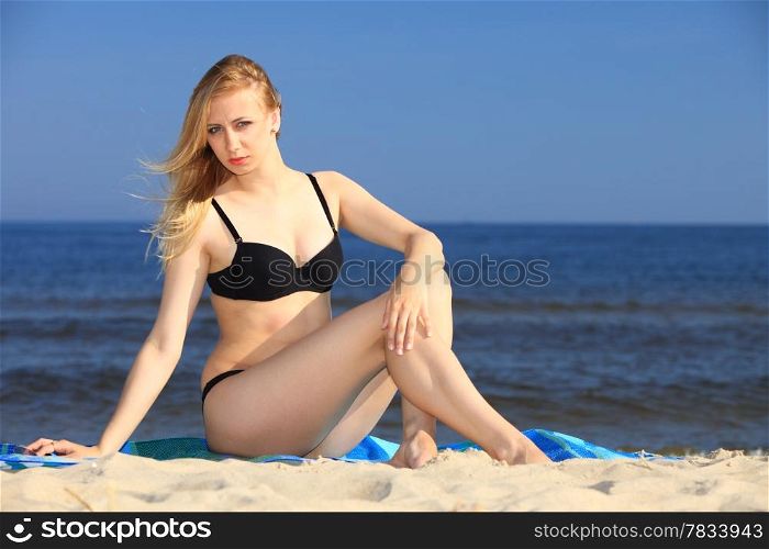 Full length woman in bikini at the sandy beach