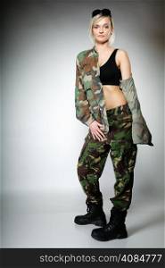 Full length woman in military clothes army girl on gray background.