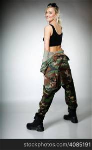 Full length woman in military clothes army girl on gray background.