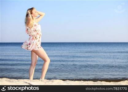 Full length woman in summer dress at the sandy beach. Vacation, summertime concept.