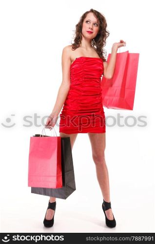 Full length young elegant woman in red dress with shopping bags isolated on white background