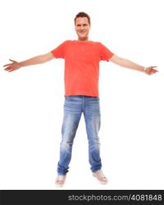 Full length young man wearing red t-shirt jeans casual fashion style arms raised isolated on white background