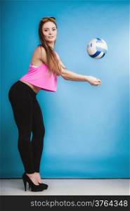 Full length young woman fashion girl casual style long hair high heels playing ball on blue background