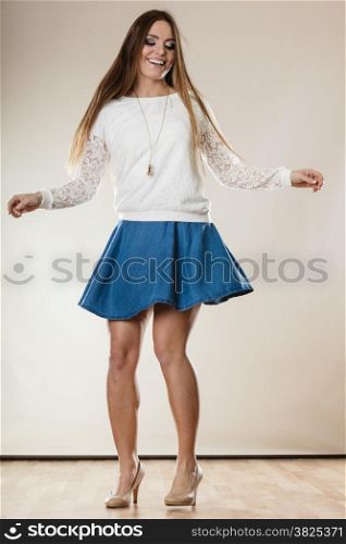Full length young woman in dance. Happy smiling girl long hair in dancing. Party.