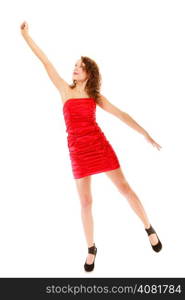 Full length young woman teen girl in elegant red dress raise her hand up holding imaginary invisible balloons and flying isolated on white background