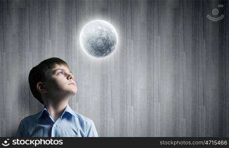 Full moon. Cute boy of school age looking at moon