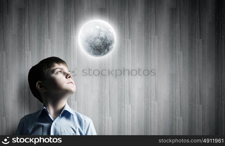 Full moon. Cute boy of school age looking at moon