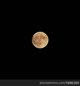 Full moon over dark black sky at night