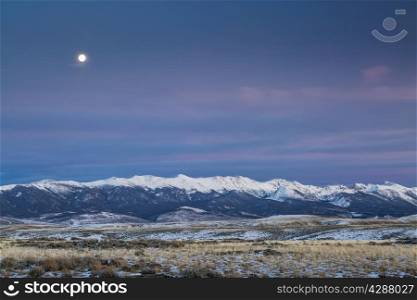 full moon over snowy Medicine Bow Mountains, North Park near Walden, Colorado