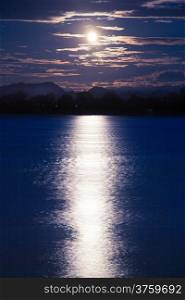 Full moon shining down on the river. A calm river at night.