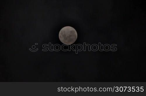 Full moon shot with light clouds passing by