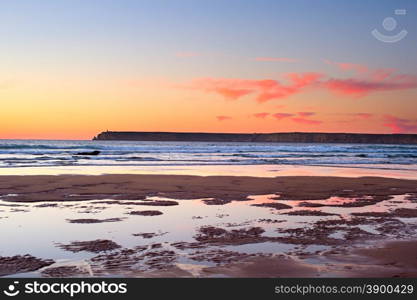 Full of different colors sunset on the ocean shore of Portugal. Algarve region