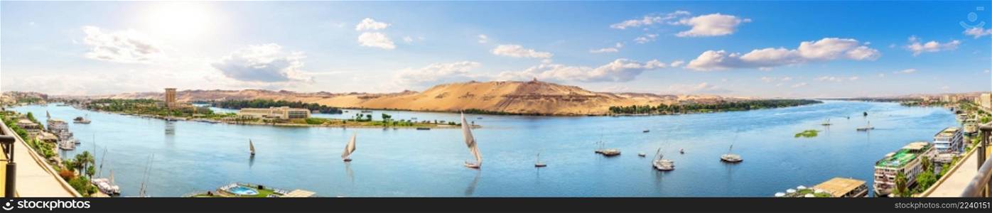 Full panorama of the Nile and sailboats by the banks of Aswan, Egypt.. Full panorama of the Nile and sailboats by the banks of Aswan, Egypt