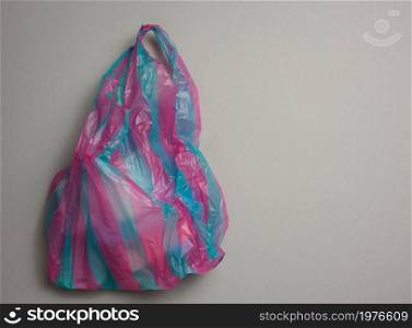 full plastic bag on gray background, top view
