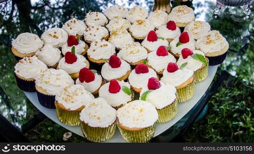 full plate of cup cakes on party table