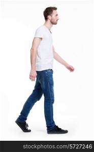 Full portrait of walking man in white t-shirt casuals - isolated on white.