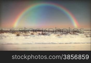Full Rainbow and Ocean Surf Waves after Sunset (or Sunrise) Rain Storm. Great for themes of promise, hope, forgiveness, God, weather, future, goodwill, nature, cruising, travel, backgrounds...