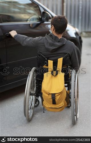 full shot disabled man opening car door