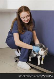 full shot doctor holding cat with leg injury