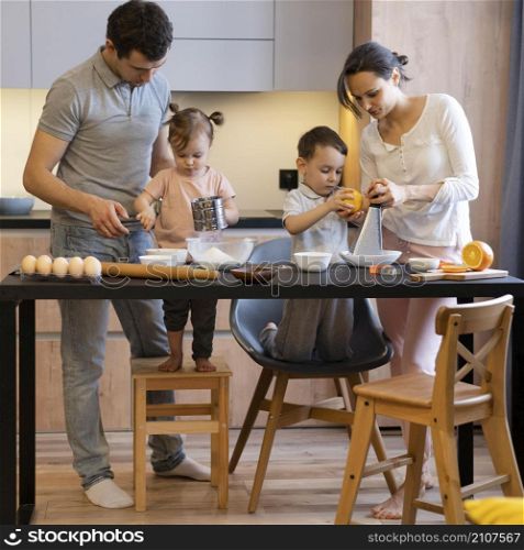 full shot family preparing food