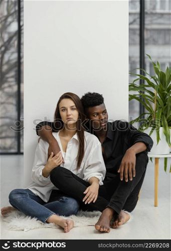 full shot interracial couple posing