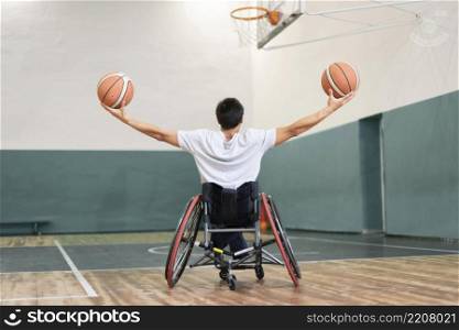full shot man holding basketballs