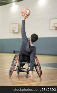 full shot man wheelchair basketball court