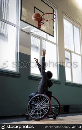 full shot man wheelchair playing basketball