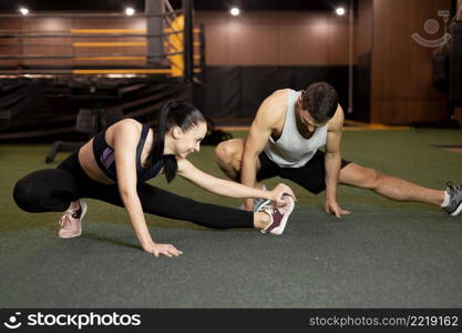 full shot man woman stretching