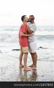 full shot men kissing shore