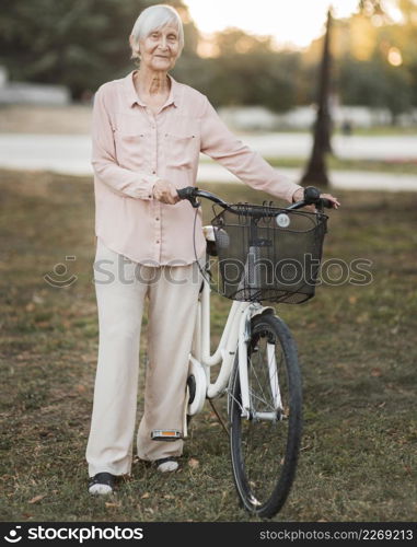 full shot old woman with bicycle