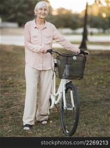 full shot old woman with bicycle