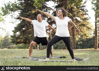 full shot seniors exercising together