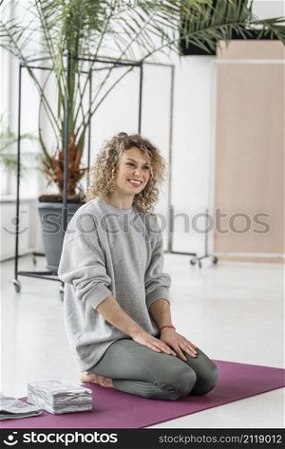full shot smiley woman yoga mat