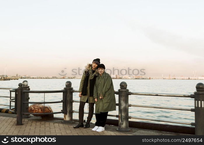 full shot winter couple posing outdoors