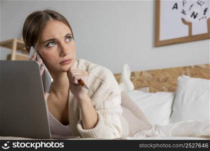 full shot woman bed with laptop