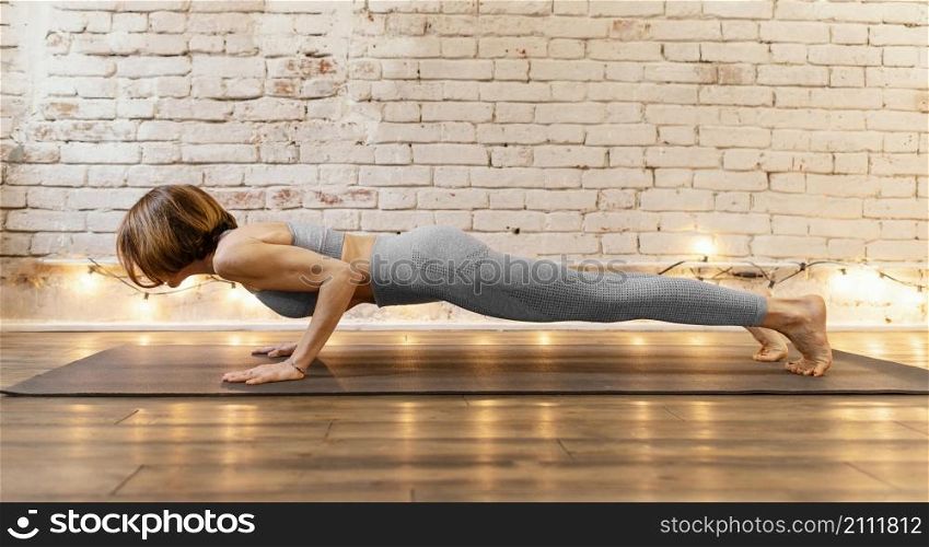 full shot woman doing plank