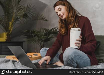 full shot woman holding coffee cup