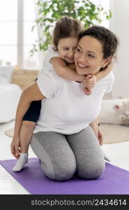 full shot woman holding girl back